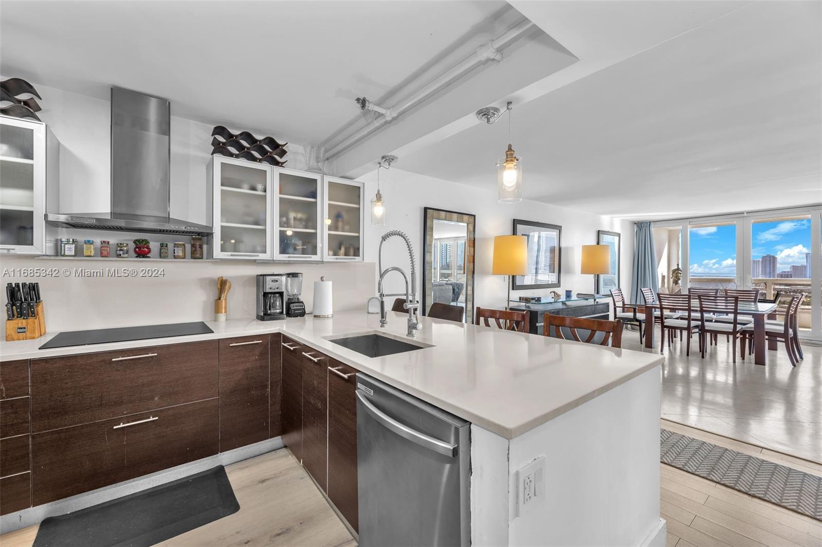 Omni Miami, FL 33132 - Photo 47 of 51 a kitchen with a sink a counter and chairs