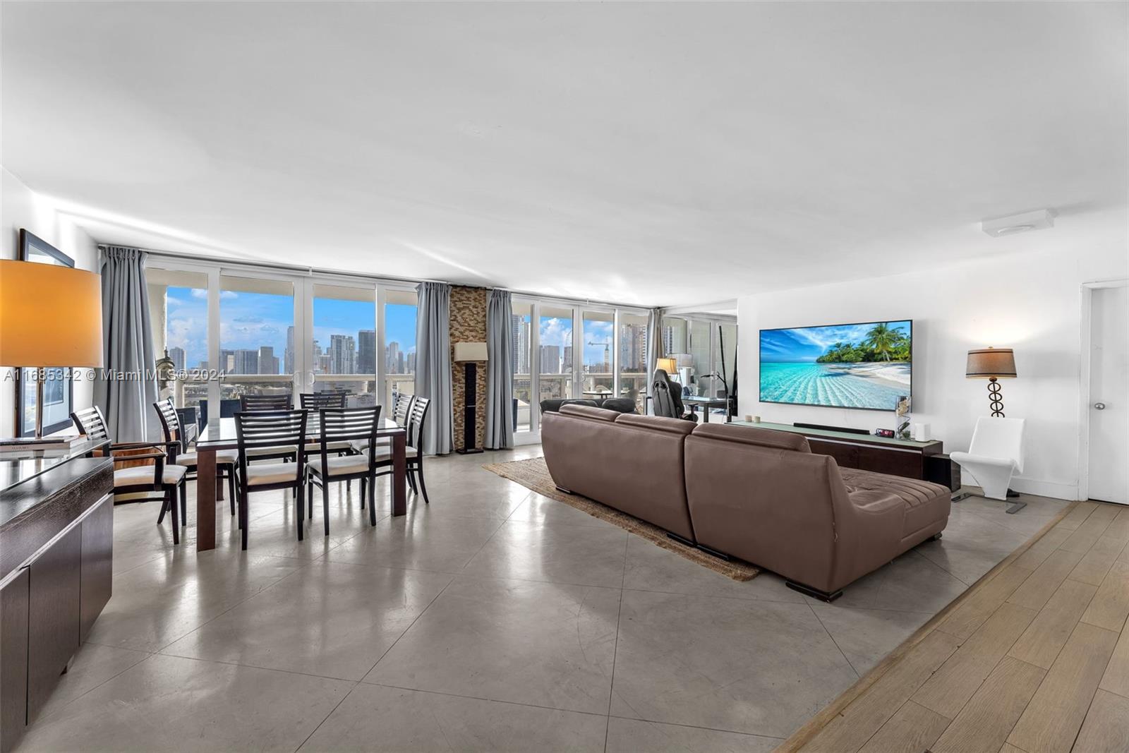 Omni Miami, FL 33132 - Photo 5 of 51 a living room with furniture and a flat screen tv