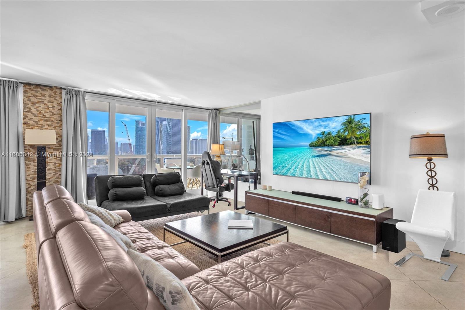 Omni Miami, FL 33132 - Photo 6 of 51 a living room with furniture and a flat screen tv