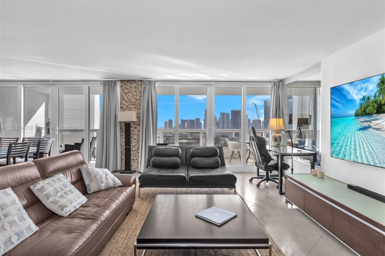 Omni Miami, FL 33132 - Photo 8 of 51 a living room with furniture and a floor to ceiling window