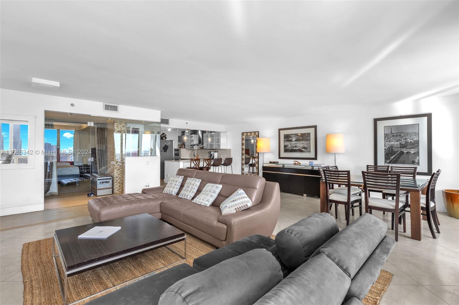 Omni Miami, FL 33132 - Photo 9 of 51 a living room with furniture kitchen view and a wooden floor