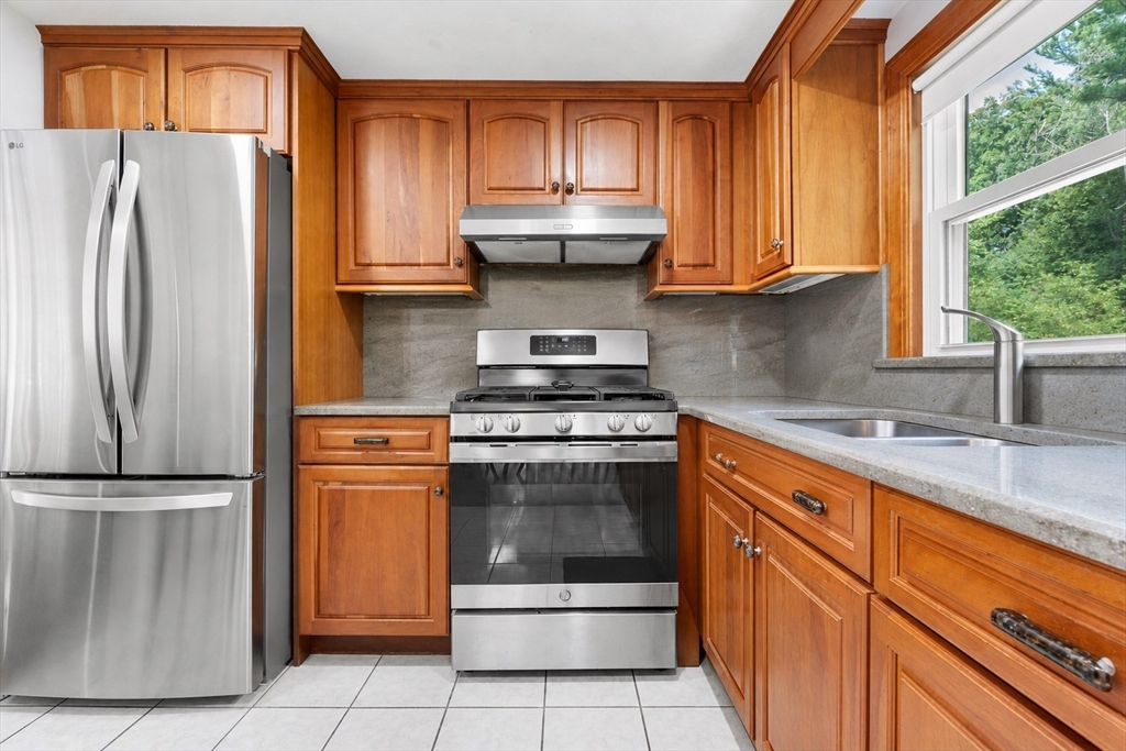 8 Governor Fuller Road Billerica, MA 01821 - Photo 14 of 33 a kitchen with stainless steel appliances granite countertop a refrigerator sink and stove
