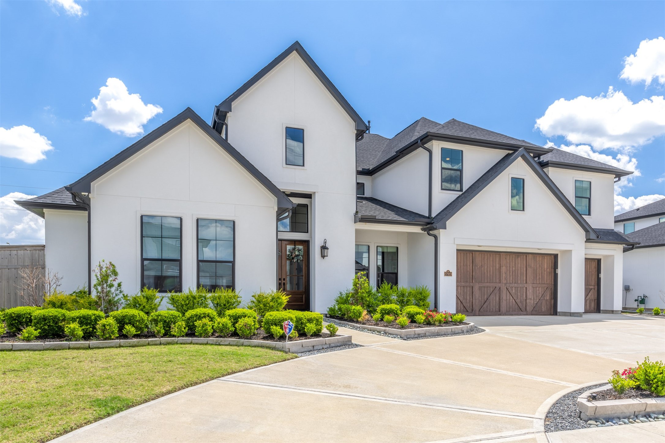 27919 Indigo Ridge Drive Fulshear, TX 77441 - Photo 48 of 50 The convenient circle driveway includes an over-sized courtyard space that's great for guest parking and kids playing away from the street. The 3 car split garage includes 8 foot tall garage doors allowing easy parking for those tall trucks and SUV's. It also includes overhead storage plus a place to park your boat in the back.