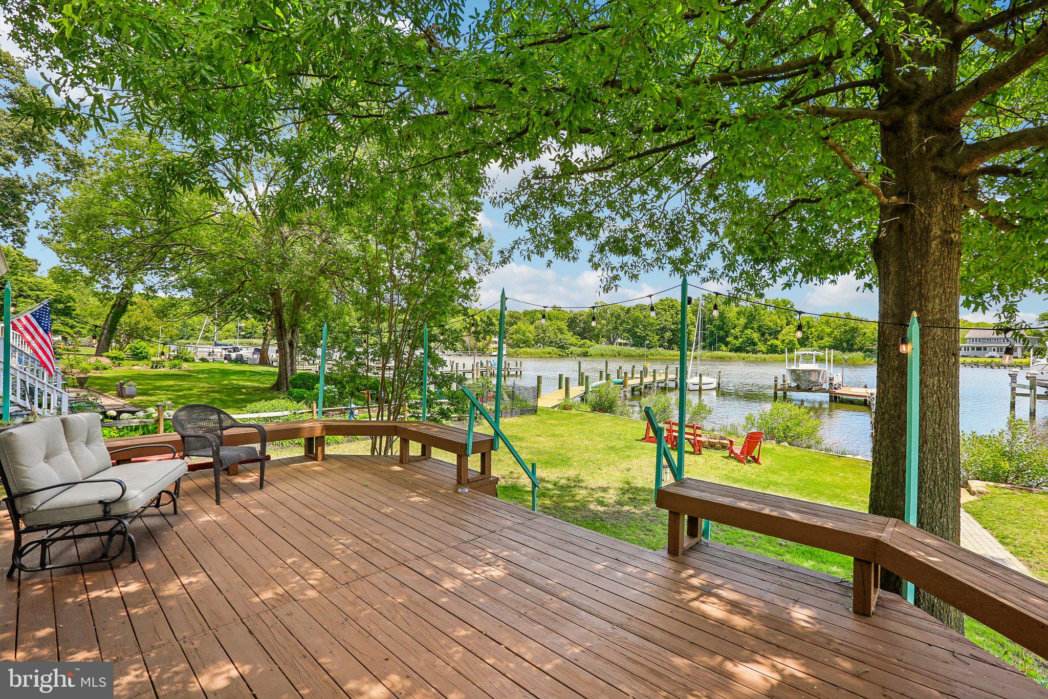 275 Gibson Road Pasadena, MD 21122 - Photo 33 of 59 Serene lakeside retreat with lush greenery.