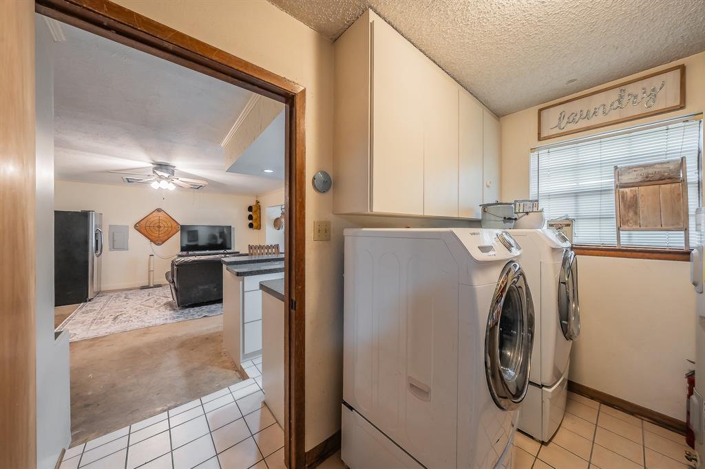 11485 Ridgeview Circle Fort Worth, TX 76244 - Photo 13 of 40 Laundry room with wall of shelves for pantry