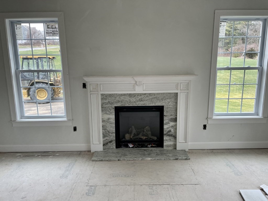 7 Applegate Road Medway, MA 02053 - Photo 9 of 10 an empty room with windows and fireplace