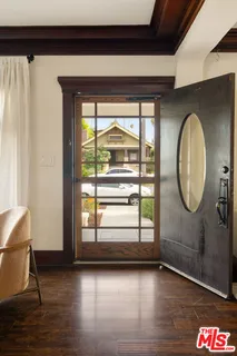 a view of a room with wooden floor and window