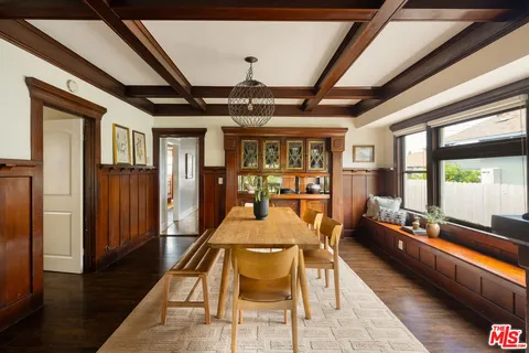 a dining room with furniture and wooden floor