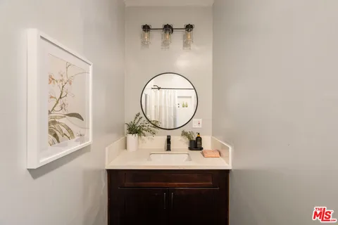 a bathroom with a shower curtain and sink