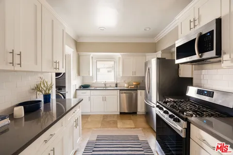 a kitchen with a stove a sink and a refrigerator