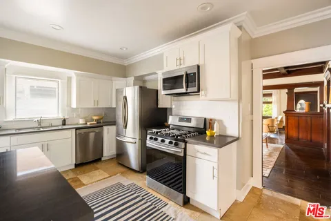 a kitchen with a sink stove and refrigerator