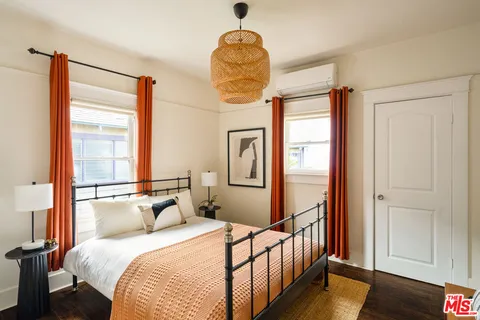 a bedroom with a bed and a chandelier