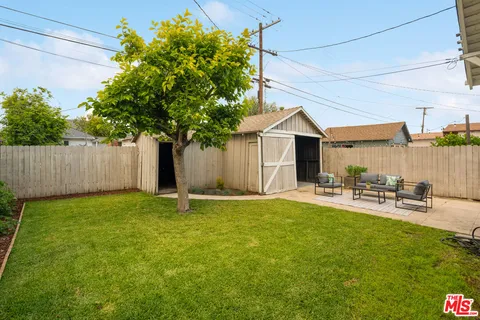 a house that has a tree in front of it