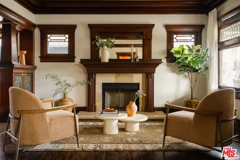 a living room with furniture a window and a fireplace