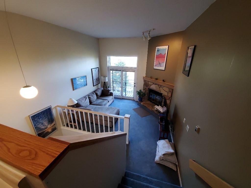 10000 Ryan Gulch Road, Unit 105 Wildernest, CO 80498 - Photo 6 of 24 a bedroom with furniture and a fireplace