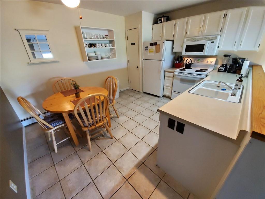 10000 Ryan Gulch Road, Unit 105 Wildernest, CO 80498 - Photo 9 of 24 a living room with stainless steel appliances furniture a couch and a kitchen view