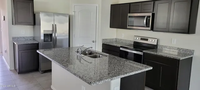 a view of a hallway with wooden floor and a bathroom