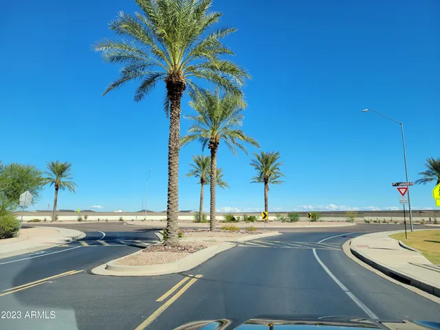 a view of a street with cars parked on the road
