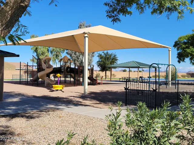 a view of a patio with a table and chairs under an umbrella