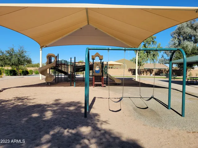 a view of swimming pool with outdoor seating and yard in back