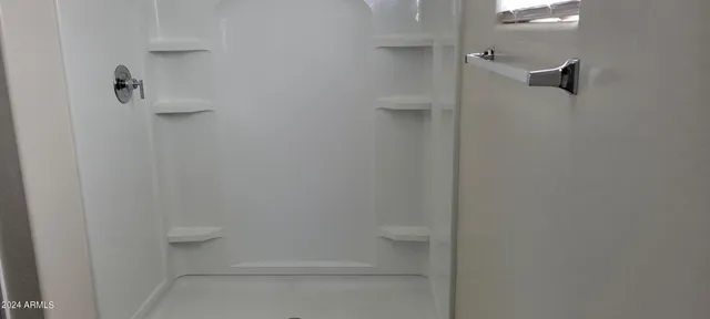 a bathroom with a shower a toilet and a sink