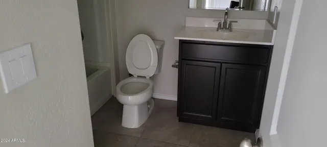 a kitchen with a granite countertop kitchen island a stove a sink and a microwave