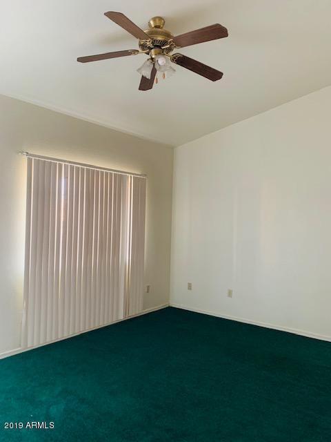 704 Elizabeth Avenue Douglas, AZ 85607 - Photo 5 of 10 an empty room with a projector and a fan