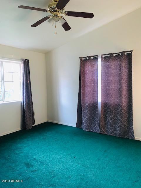 704 Elizabeth Avenue Douglas, AZ 85607 - Photo 10 of 10 a view of an empty room with wooden floor and a window