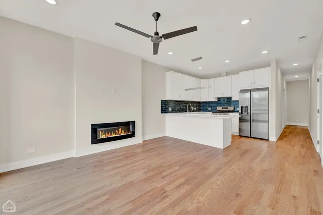 a view of a kitchen with a sink and a refrigerator