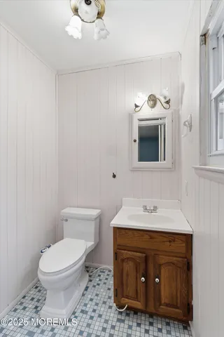 a bathroom with a sink toilet and mirror
