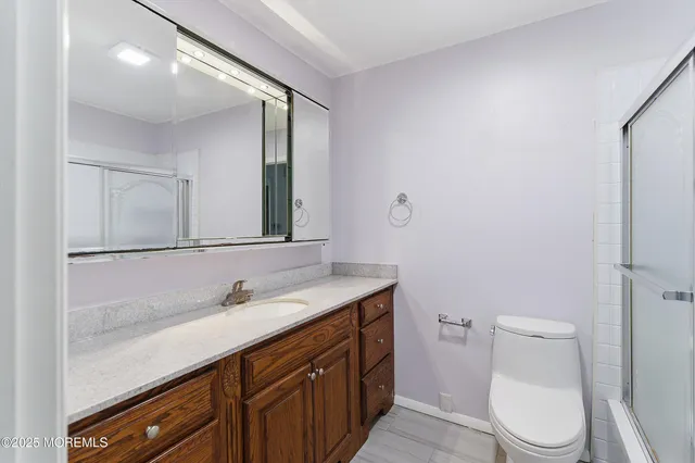 a bathroom with a sink a toilet and mirror