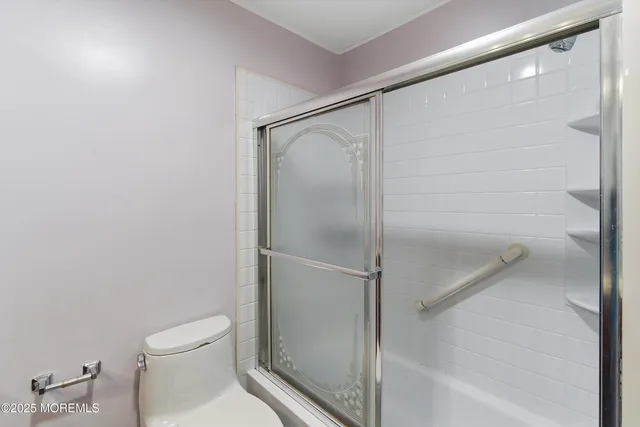 a bathroom with a shower and a toilet
