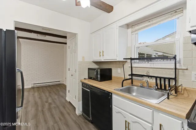 a kitchen with a sink a microwave a stove and refrigerator