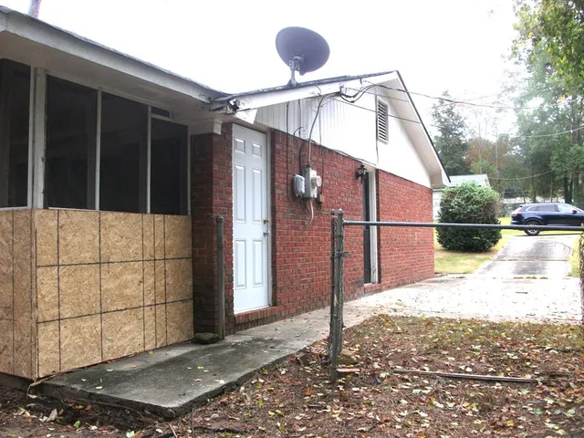 a front view of house with a garden