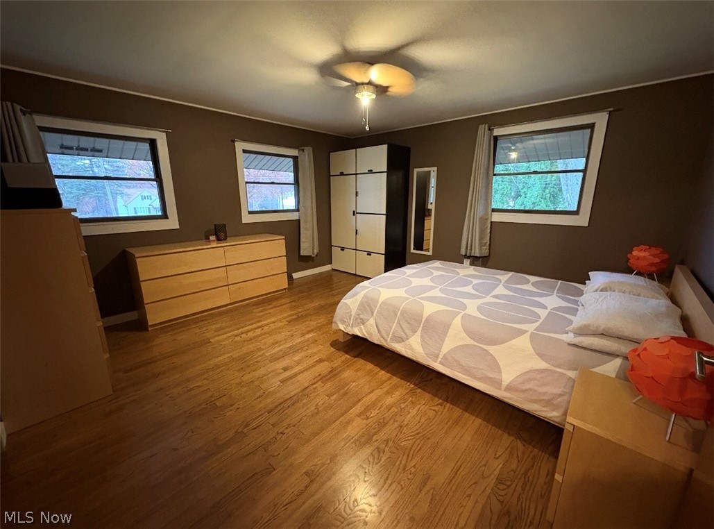 17583 Shurmer Road Strongsville, OH 44136 - Photo 29 of 50 Hardwood-finish flooring throughout, featuring a ceiling fan with integrated lighting and multiple windows