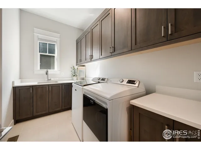 a utility room with sink dryer and washer