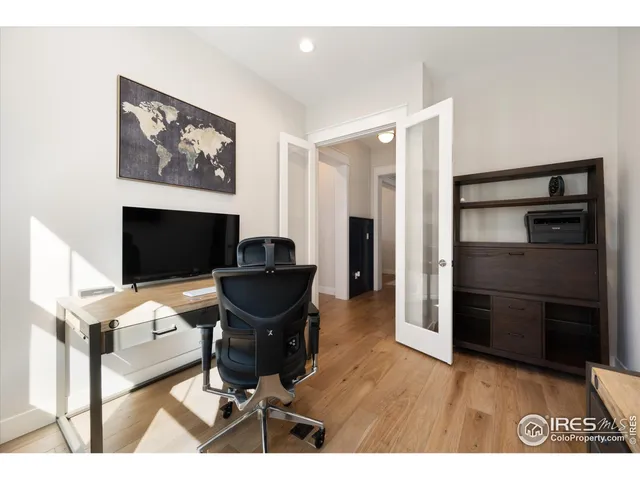 a view of a workspace with furniture and a flat screen tv