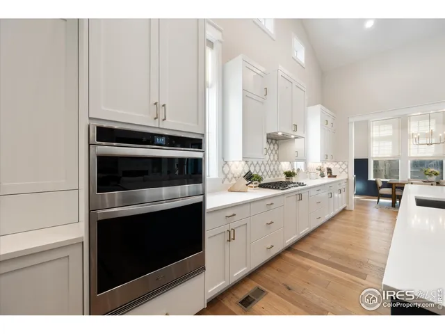 a kitchen with granite countertop white cabinets and appliances