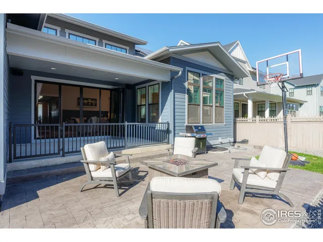 a view of a patio with table and chairs and potted plants