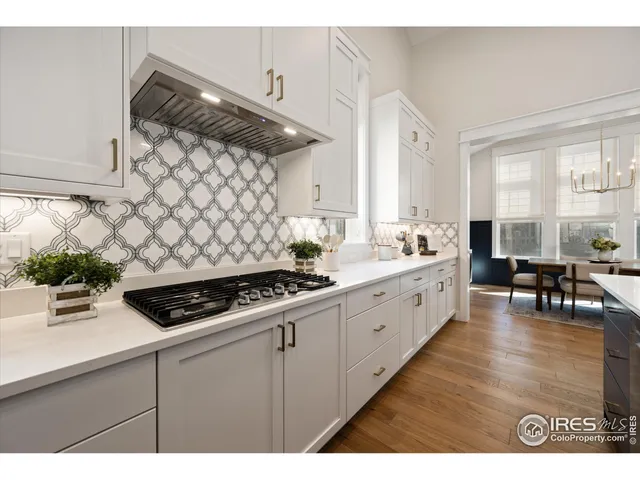 a kitchen with a sink a stove and cabinets
