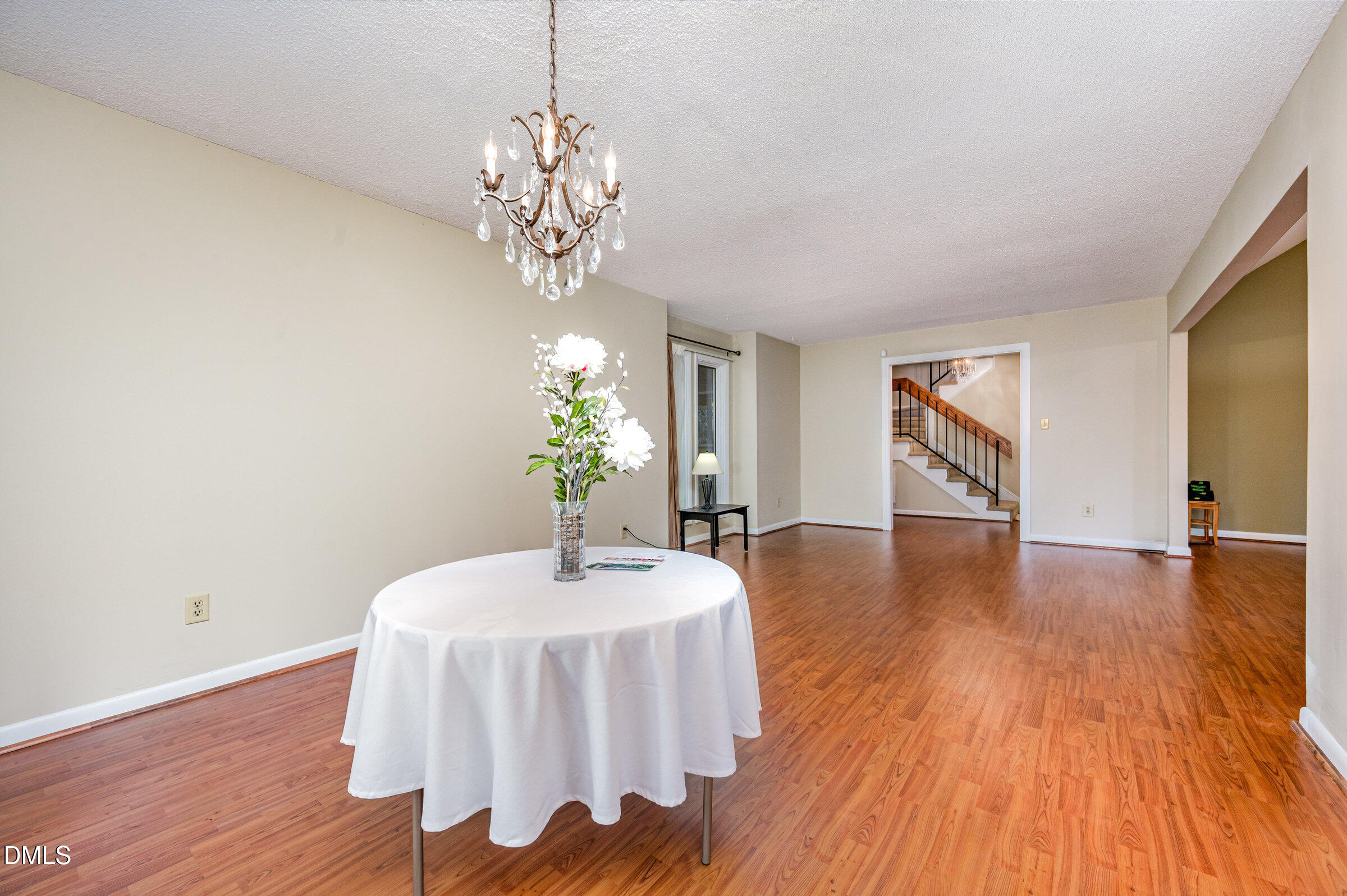 2900 Sylvania Drive Raleigh, NC 27607 - Photo 13 of 36 a dining room with chandelier and wooden floor