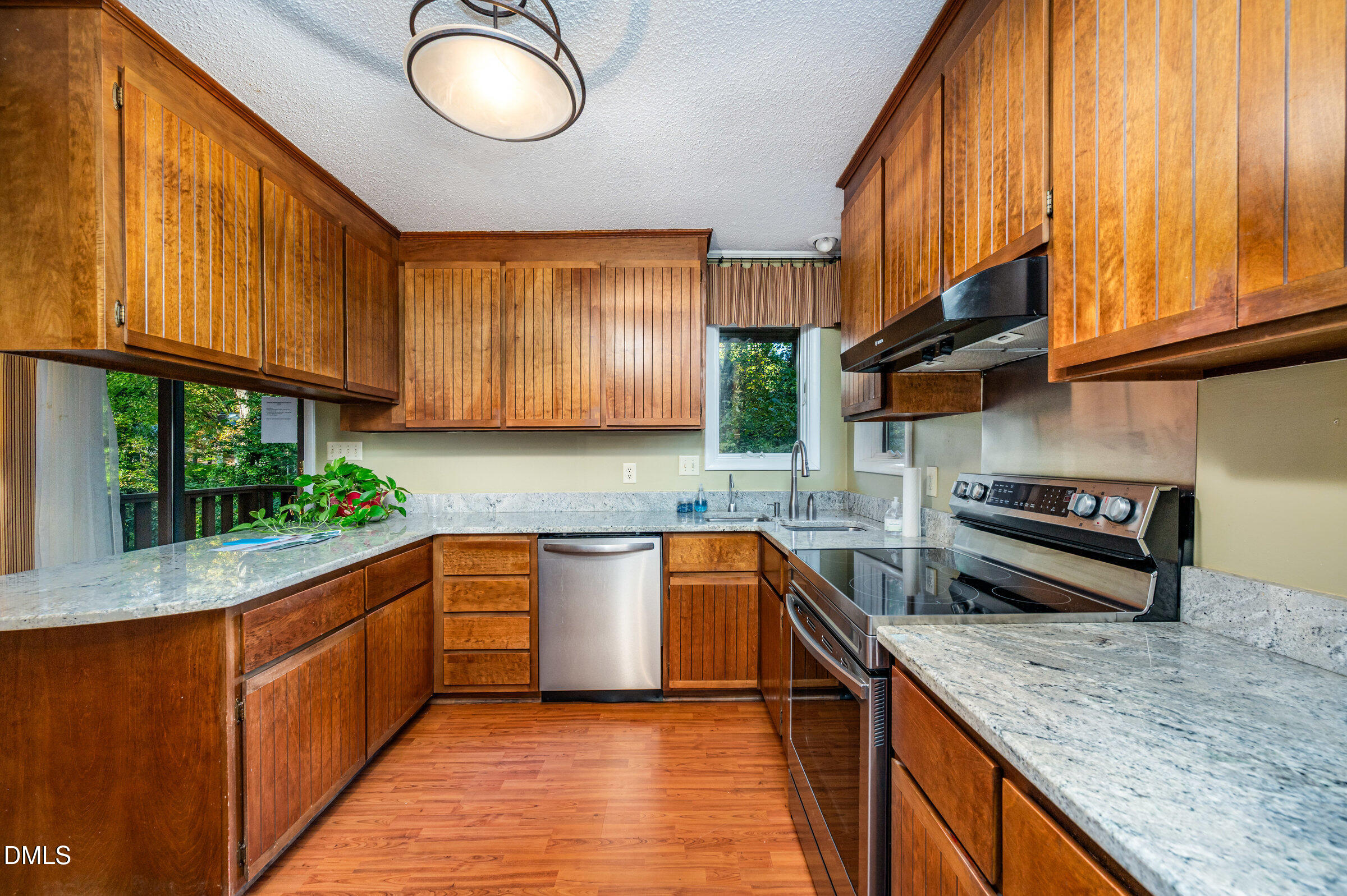 2900 Sylvania Drive Raleigh, NC 27607 - Photo 18 of 36 a kitchen with stainless steel appliances granite countertop a sink a stove and a wooden cabinets