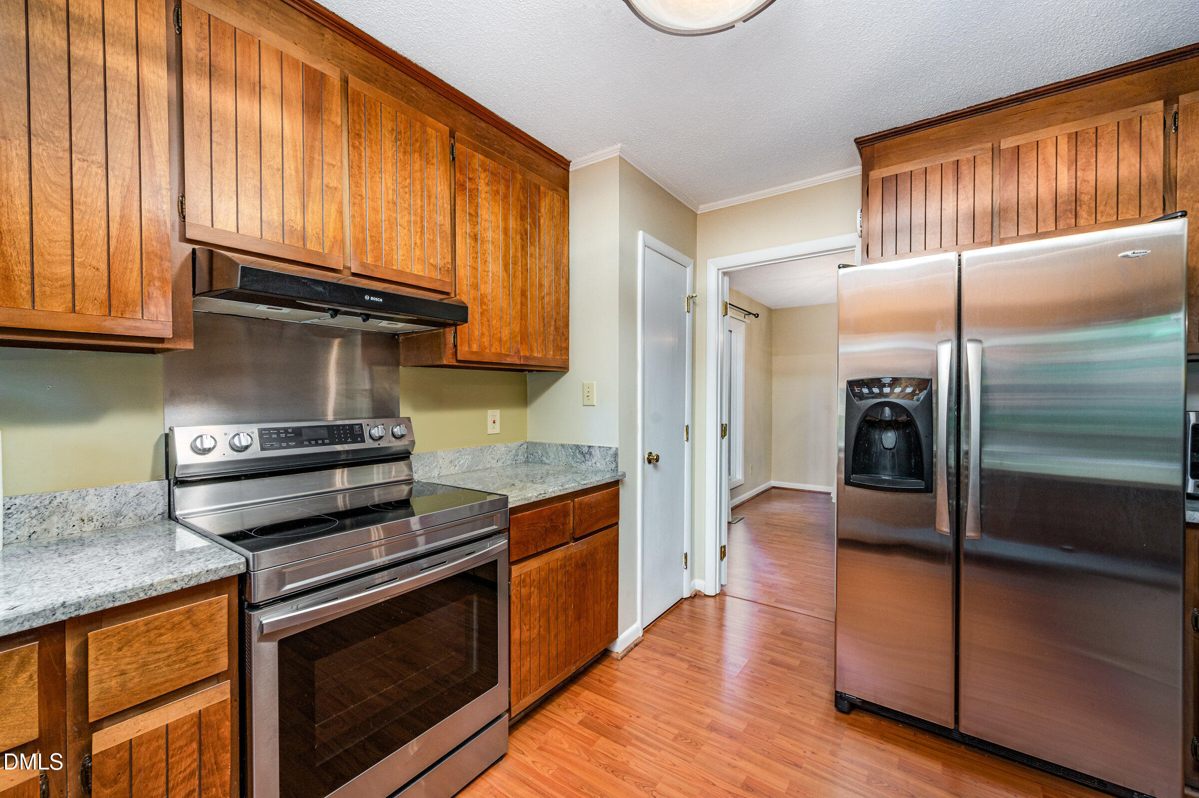 2900 Sylvania Drive Raleigh, NC 27607 - Photo 19 of 36 a kitchen with granite countertop stainless steel appliances and wooden cabinets