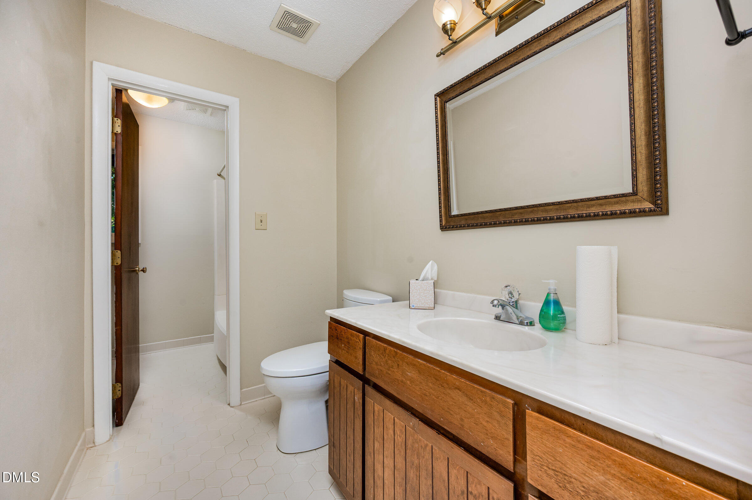 2900 Sylvania Drive Raleigh, NC 27607 - Photo 21 of 36 a bathroom with a sink a toilet and a mirror