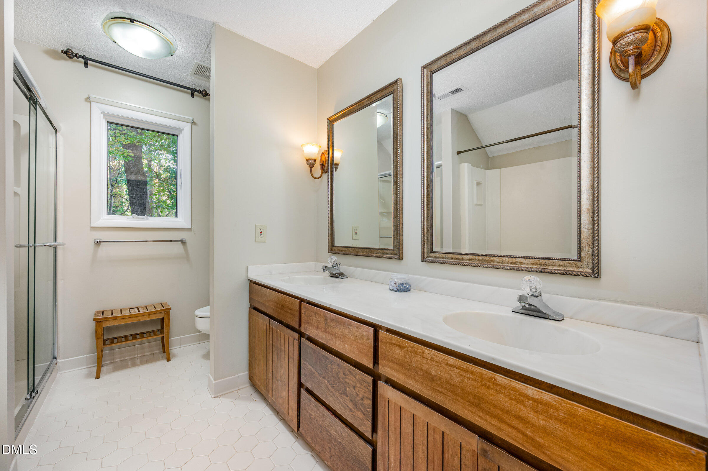 2900 Sylvania Drive Raleigh, NC 27607 - Photo 25 of 36 a bathroom with a sink and a mirror