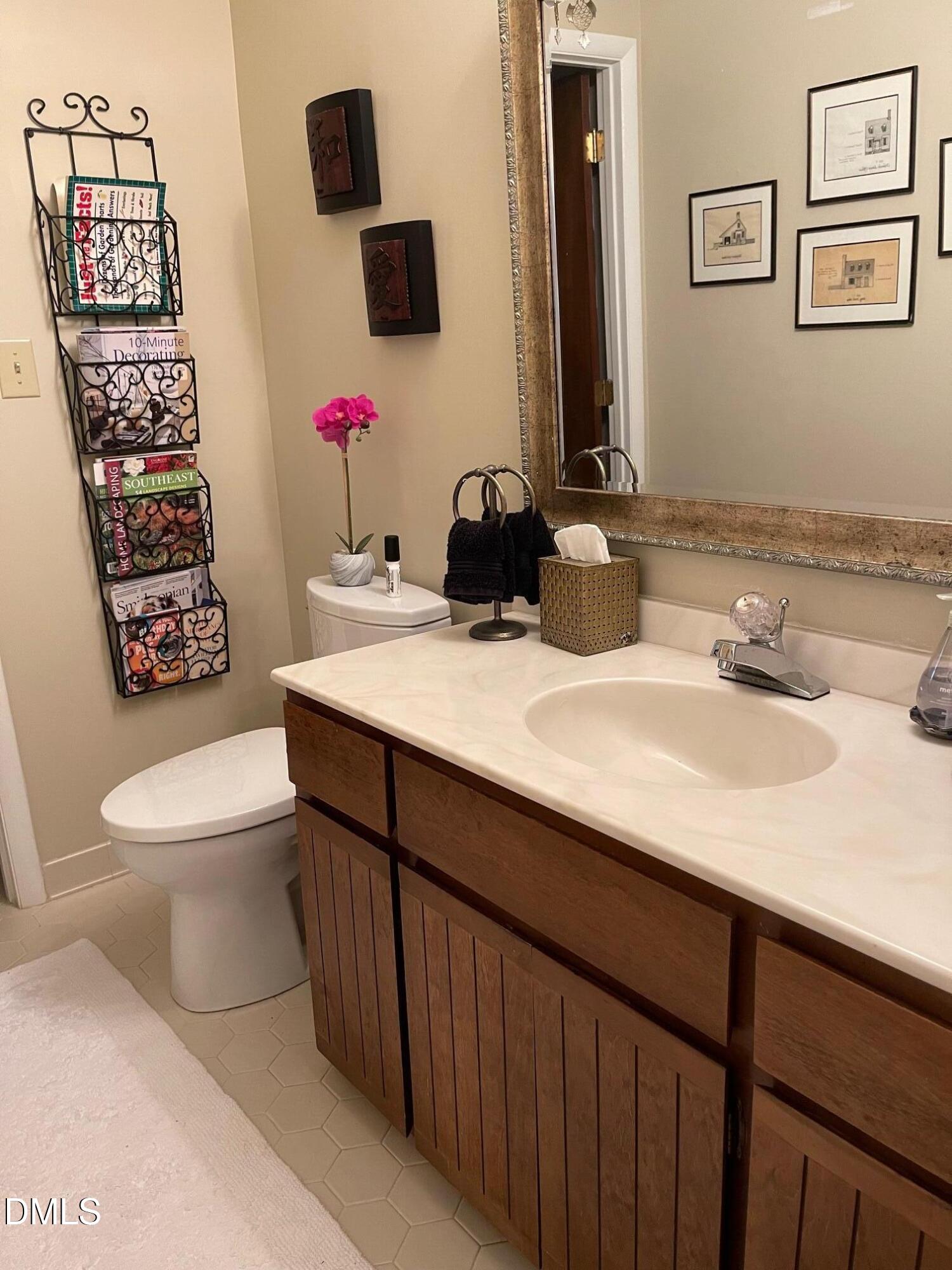2900 Sylvania Drive Raleigh, NC 27607 - Photo 29 of 49 a bathroom with a sink vanity mirror and toilet