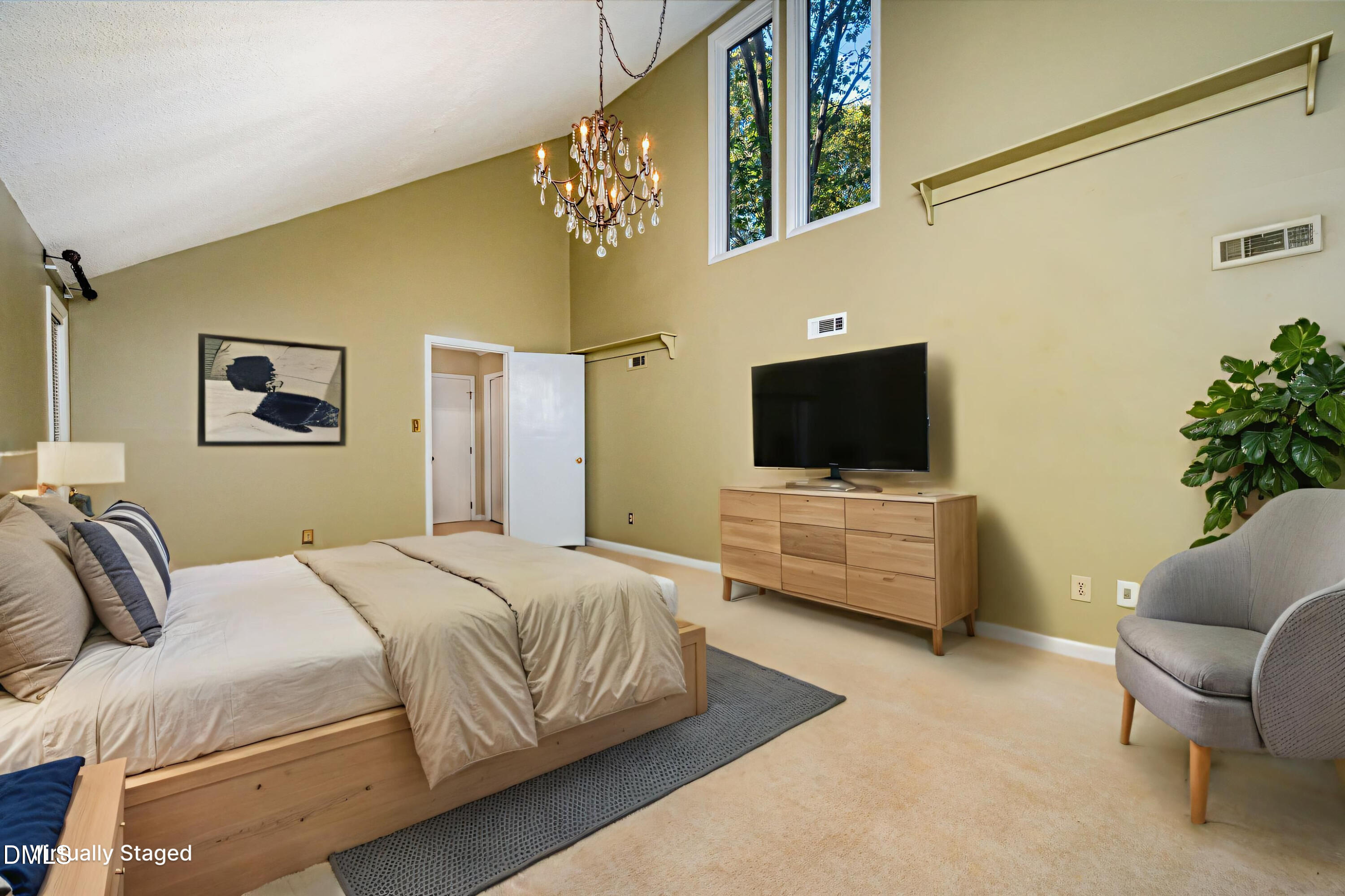 2900 Sylvania Drive Raleigh, NC 27607 - Photo 32 of 49 a bedroom with a bed and a flat screen tv