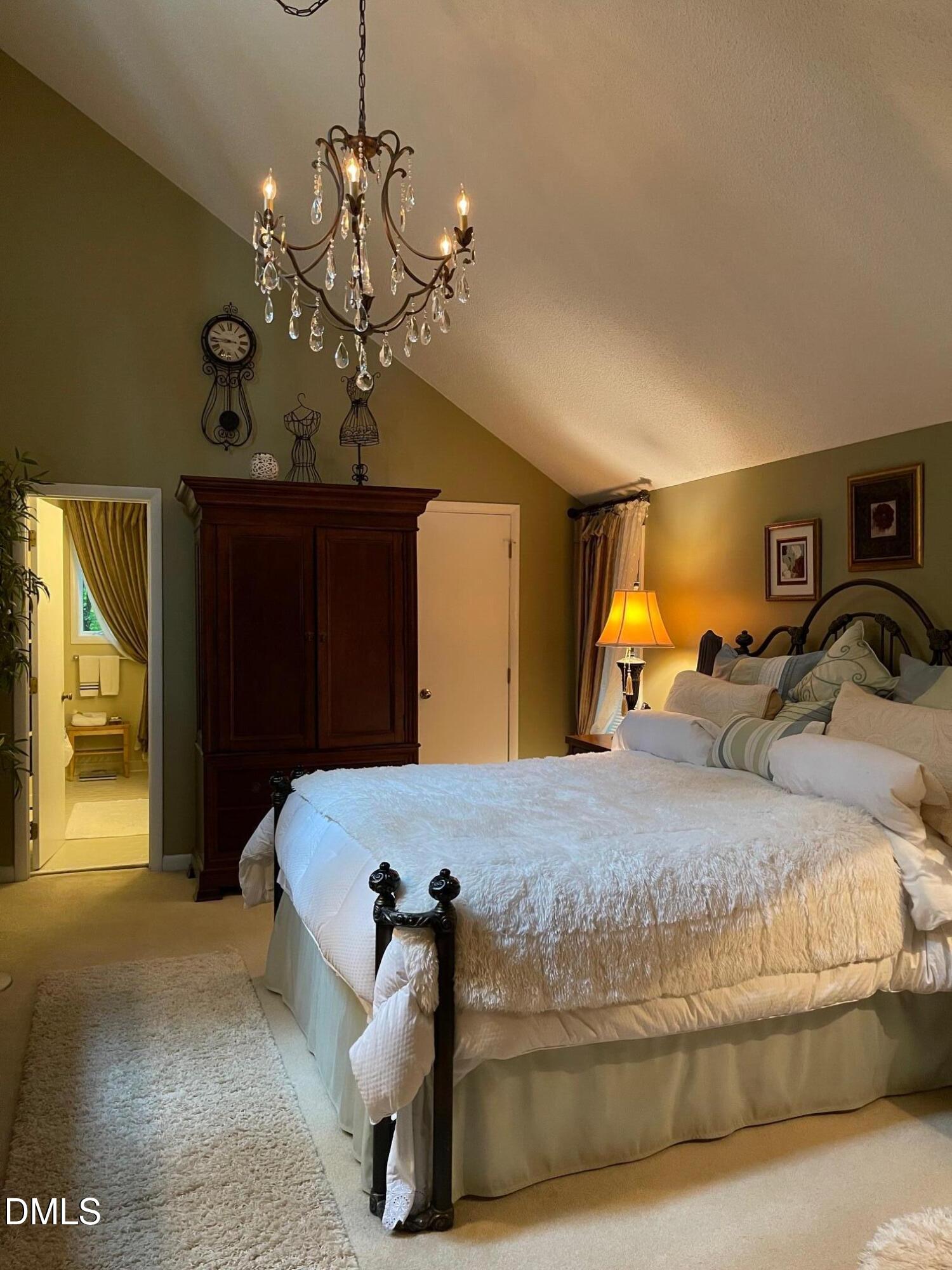 2900 Sylvania Drive Raleigh, NC 27607 - Photo 33 of 49 a bedroom with a bed and a chandelier