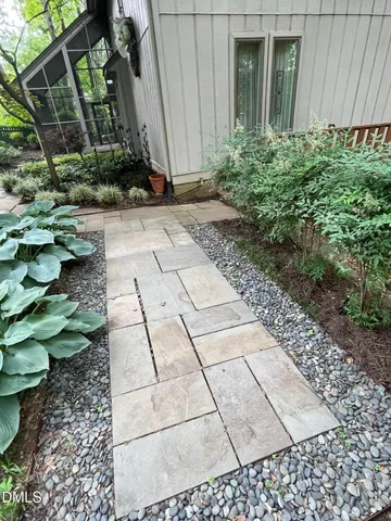 a view of a house with a yard and sitting area