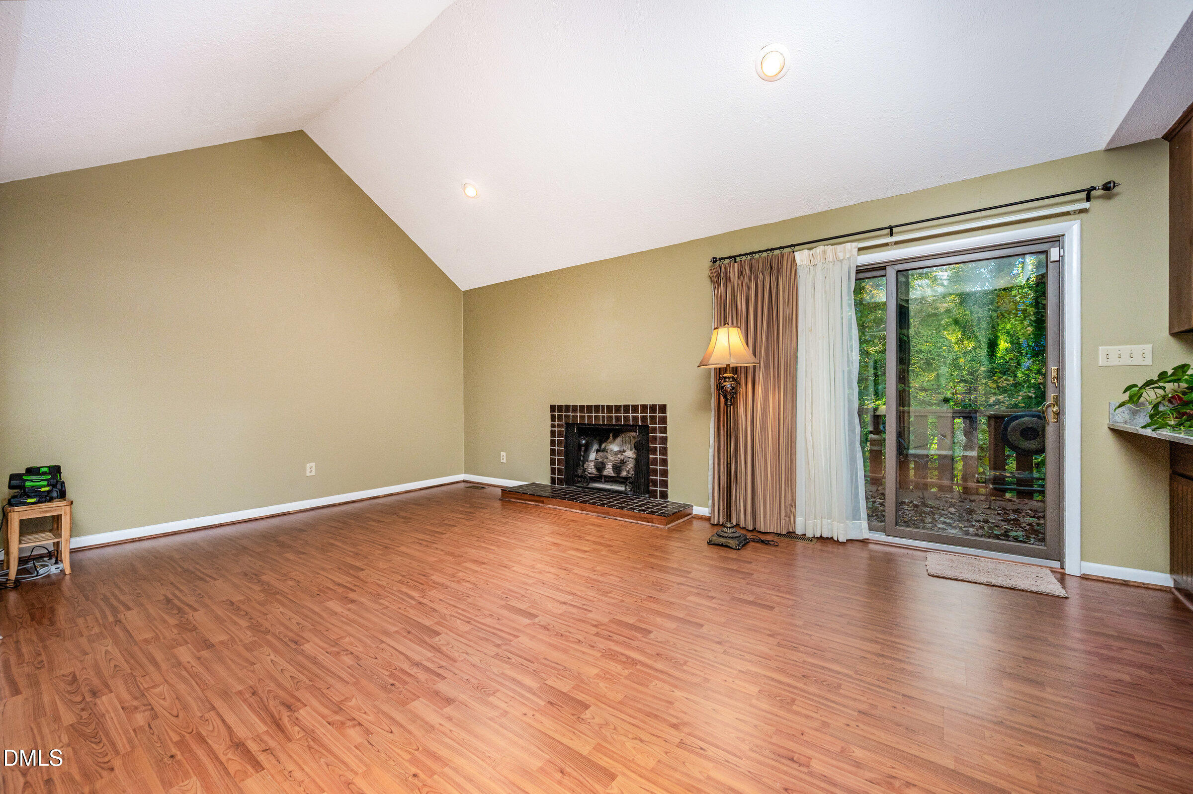 2900 Sylvania Drive Raleigh, NC 27607 - Photo 7 of 36 a view of a livingroom with wooden floor and a fireplace